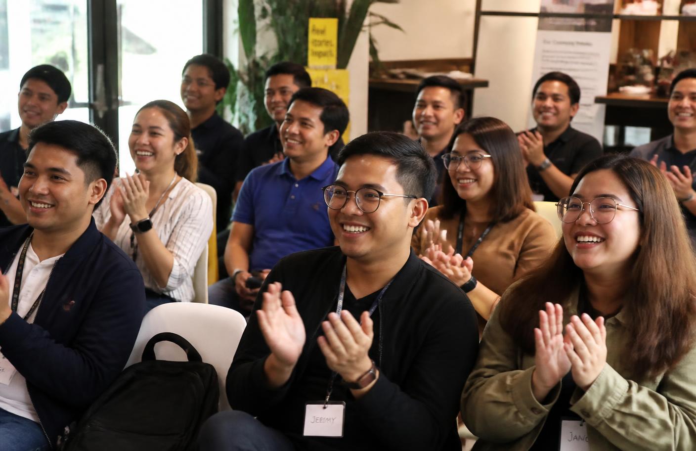 Filipino professionals applauding at a VA Heroes PH community training session